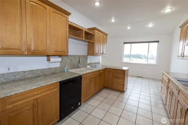 a kitchen with a sink a stove cabinets and counter space