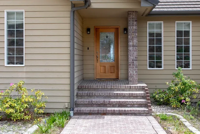 a front view of a house with a garden