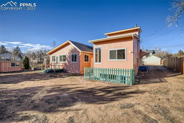 a view of house with a yard