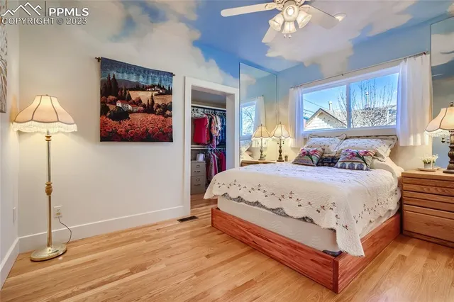 a bedroom with a large bed and a chandelier