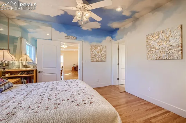 a bedroom with a large bed and a chandelier