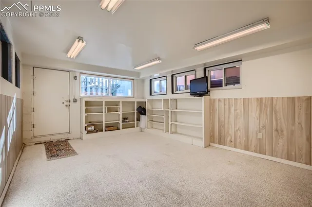 a view of a livingroom with furniture and closet area