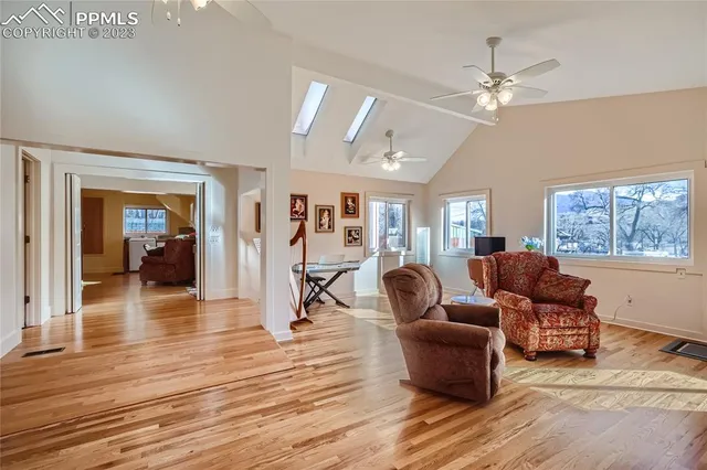 a living room with furniture and wooden floor