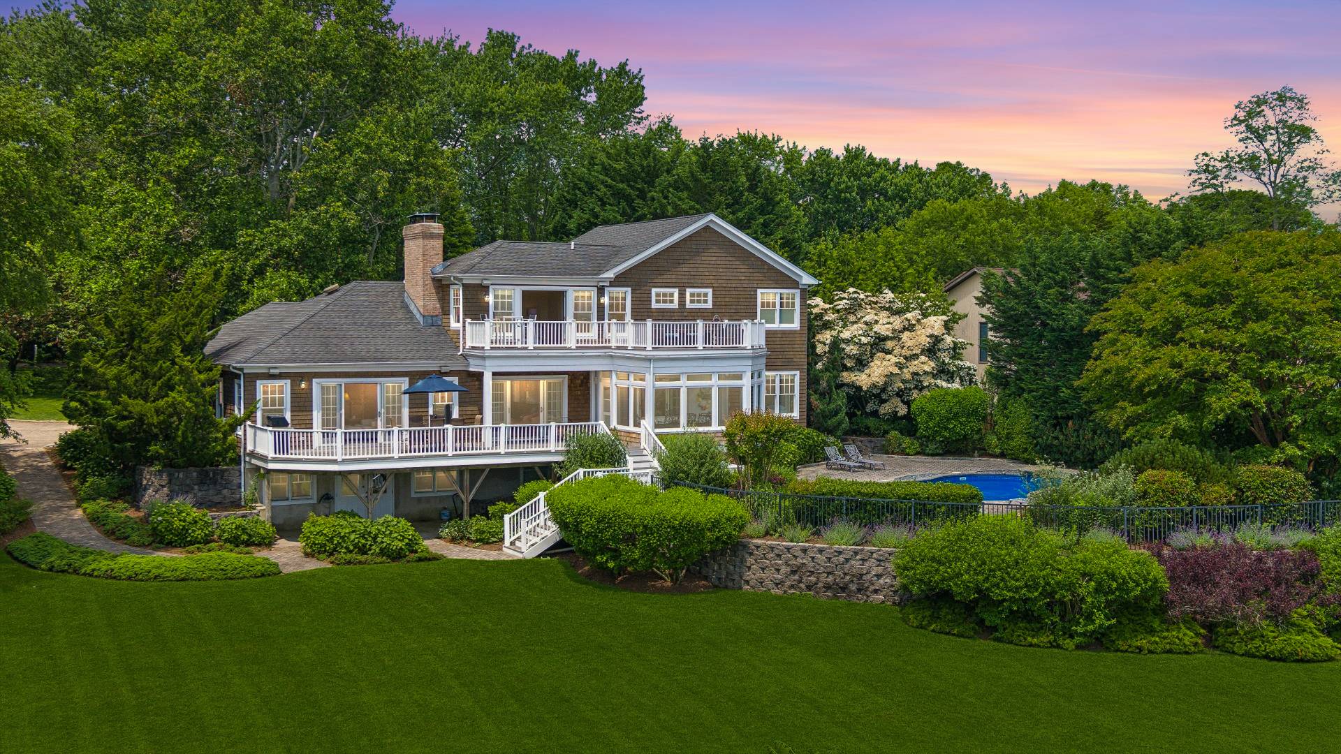 a front view of a house with a yard and trees