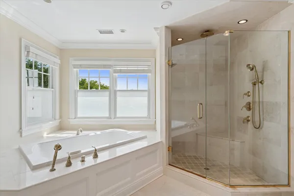 a bathroom with a tub and a shower