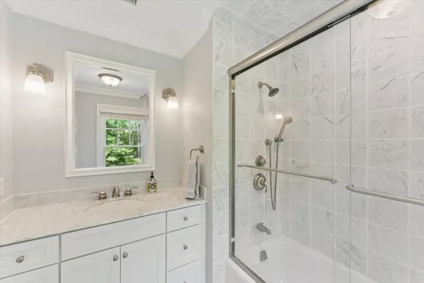 a bathroom with a bathtub shower sink and mirror