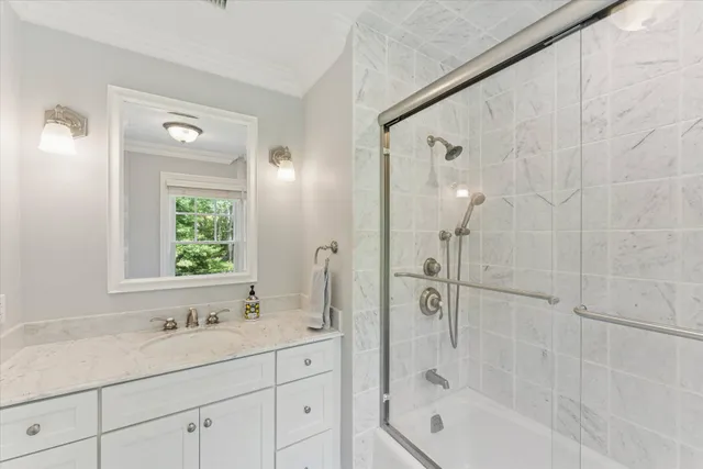 a bathroom with a bathtub shower sink and mirror