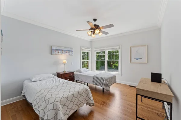 a bedroom with a bed and wooden floor