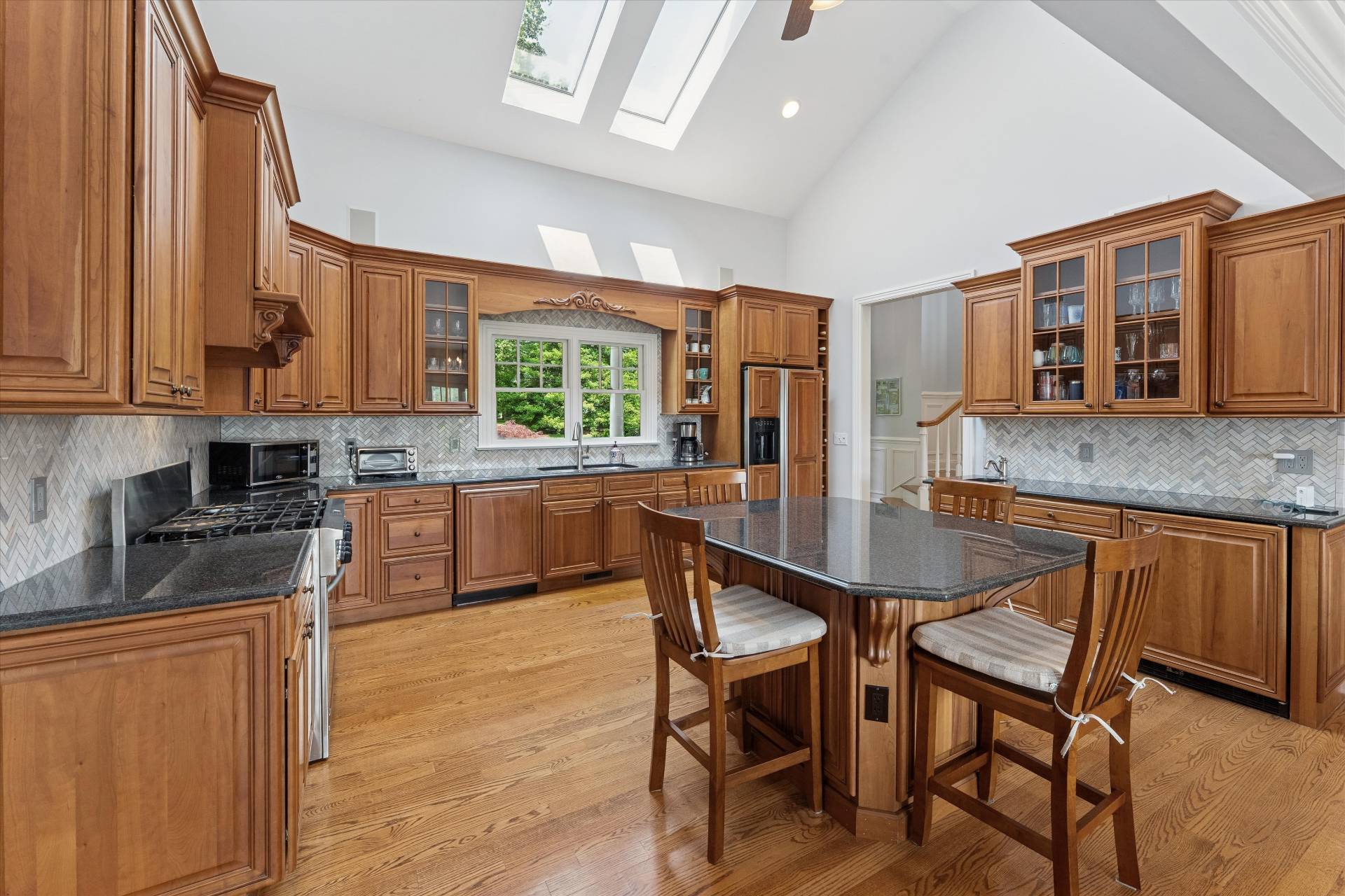 40 Overlook Drive Aquebogue, NY 11901 - Photo 4 of 32 a kitchen with granite countertop a stove a sink a dining table and chairs