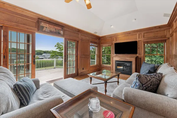 a living room with furniture a fireplace and a flat screen tv