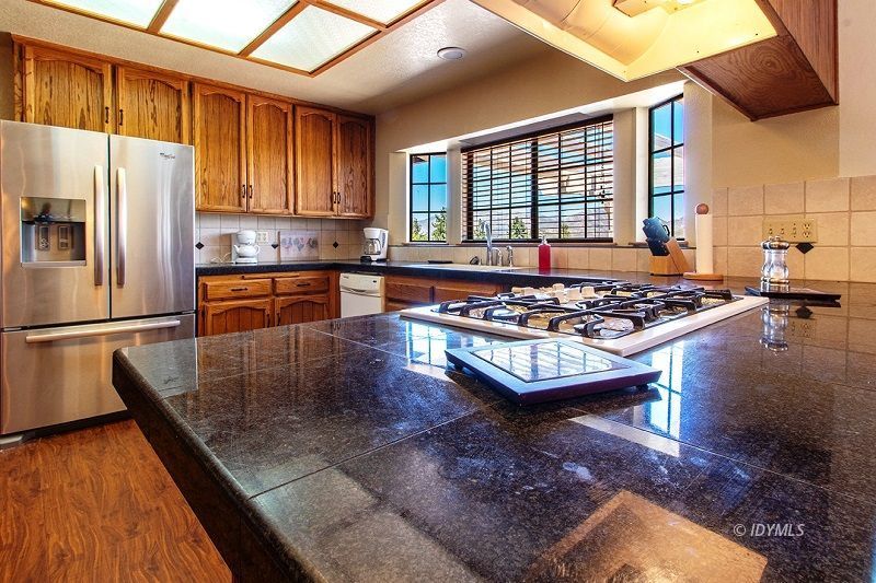 59382 Hop Patch Spring Road Mountain Center, CA 92561 - Photo 17 of 47 a kitchen with stainless steel appliances granite countertop a stove a refrigerator and a microwave