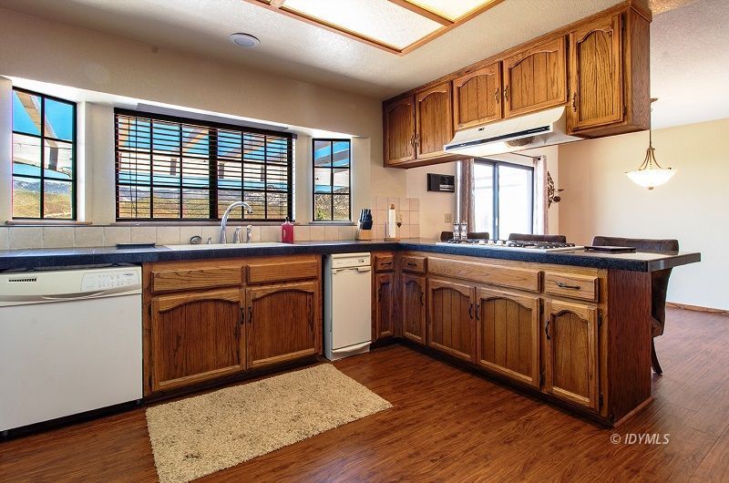 59382 Hop Patch Spring Road Mountain Center, CA 92561 - Photo 18 of 47 a kitchen with stainless steel appliances granite countertop a sink stove and cabinets