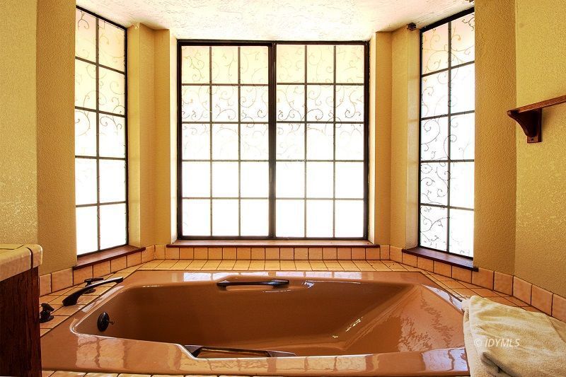 59382 Hop Patch Spring Road Mountain Center, CA 92561 - Photo 34 of 47 a bath tub sitting in a bathroom next to a window