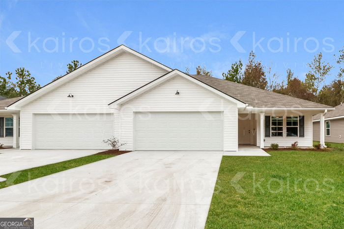 155 Cottage Grove Road Brunswick, GA 31525 - Photo 1 of 16 a front view of a house with a yard and garage
