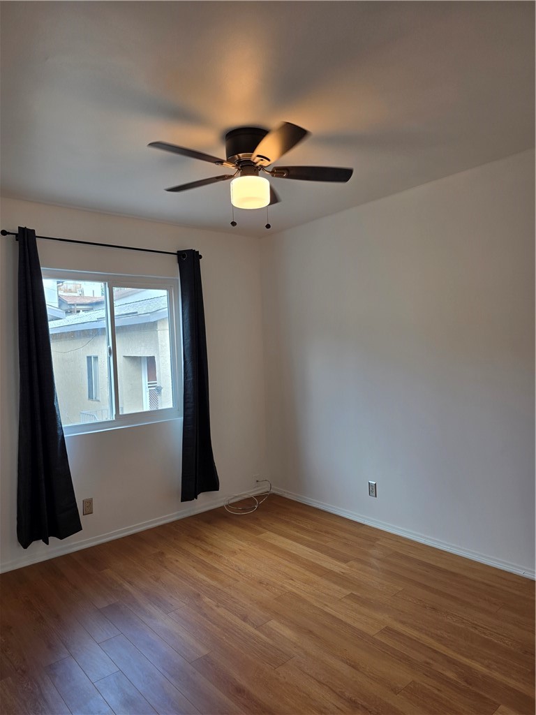3136 Perlita Avenue, Unit 1 Atwater Village, CA 90039 - Photo 3 of 10 an empty room with wooden floor fan and windows