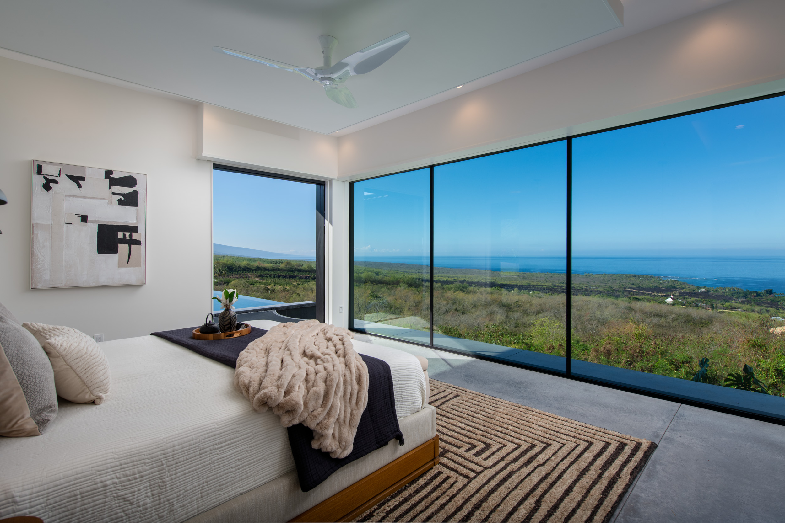 82-5879 Government Main Road Captain Cook, HI 96704 - Photo 8 of 30 a bed sitting in a bedroom next to a large window