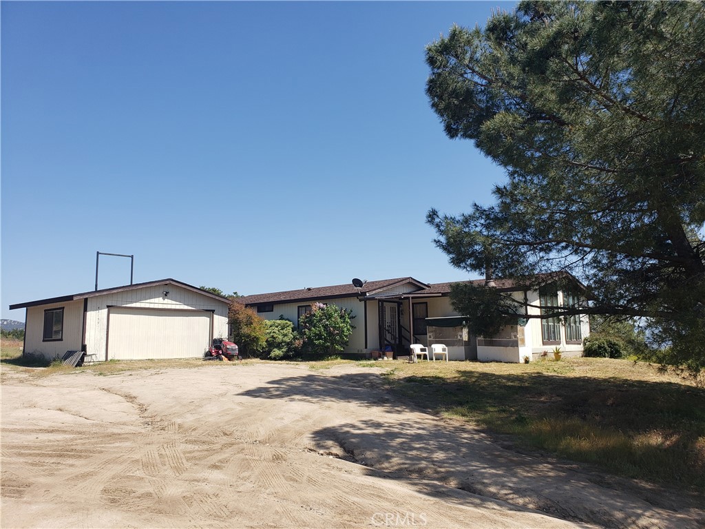 43155 Sunset Ridge Hemet, CA 92544 - Photo 1 of 1 a front view of a house with a yard and garage