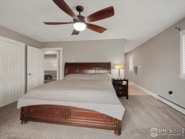 a bedroom with a bed and a ceiling fan
