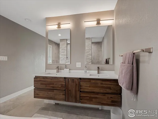a bathroom with a double vanity sink and mirror
