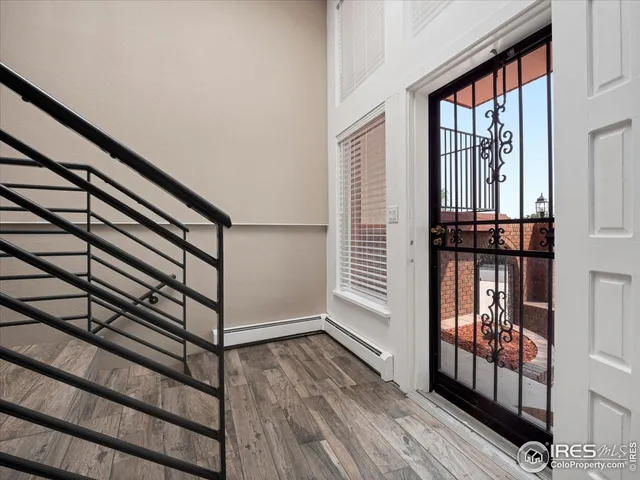 a view of an entryway with wooden floor