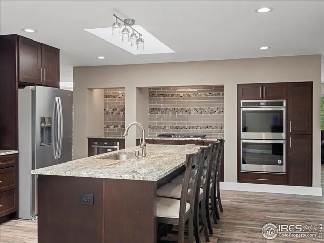 a kitchen with refrigerator cabinets and wooden floor