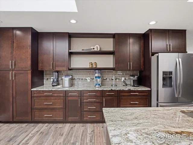 a kitchen with stainless steel appliances granite countertop a refrigerator and a sink