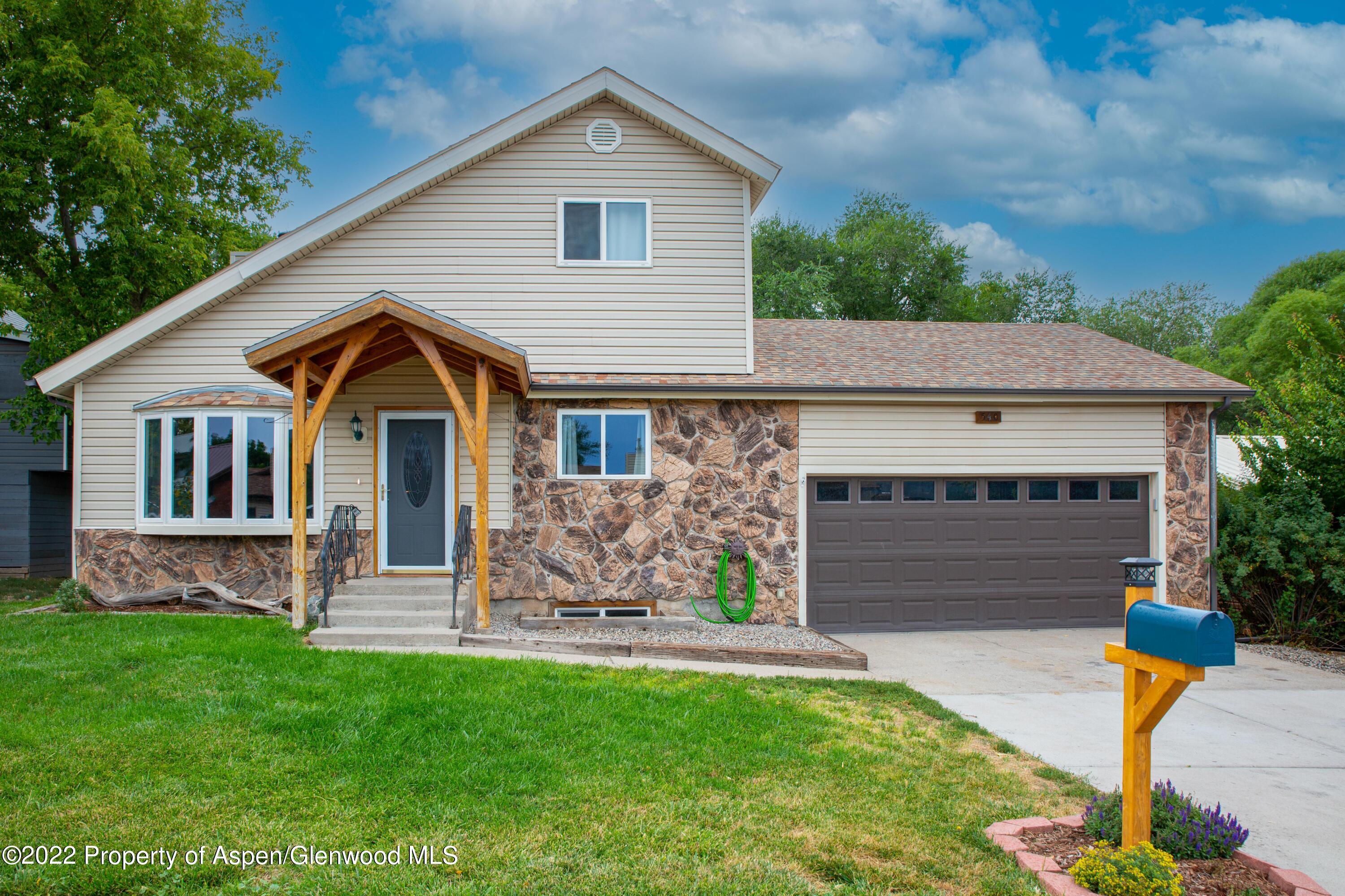 540 Ash Avenue Rifle, CO 81650 - Photo 3 of 24 a front view of a house with a yard
