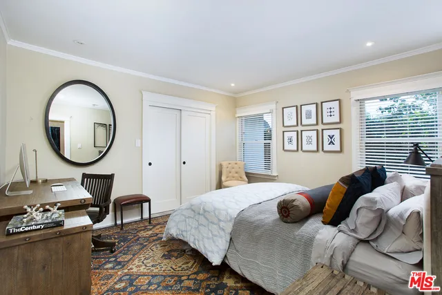 a bedroom with bed and a a mirror