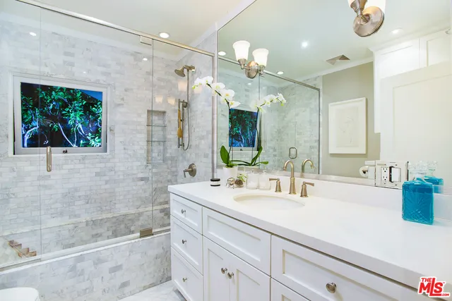 a bathroom with a double vanity sink mirror and bathtub
