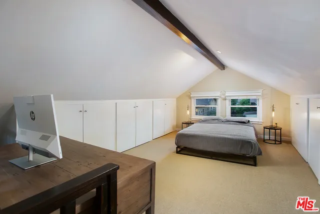 a bedroom with a bed and a desk