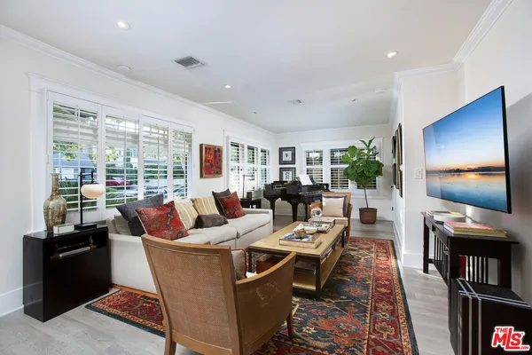 a living room with fireplace furniture and a flat screen tv