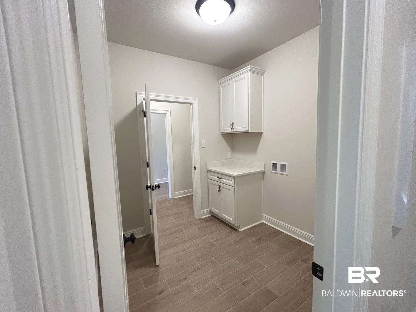 872 Sumter Loop Foley, AL 36535 - Photo 10 of 18 Laundry room with hookup for a washing machine, cabinets, and light hardwood / wood-style flooring