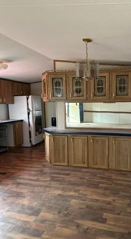 a view of a hallway with wooden floor and entryway