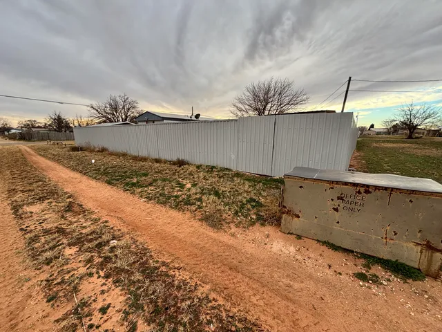 a view of a hall with floor to ceiling windows and yard