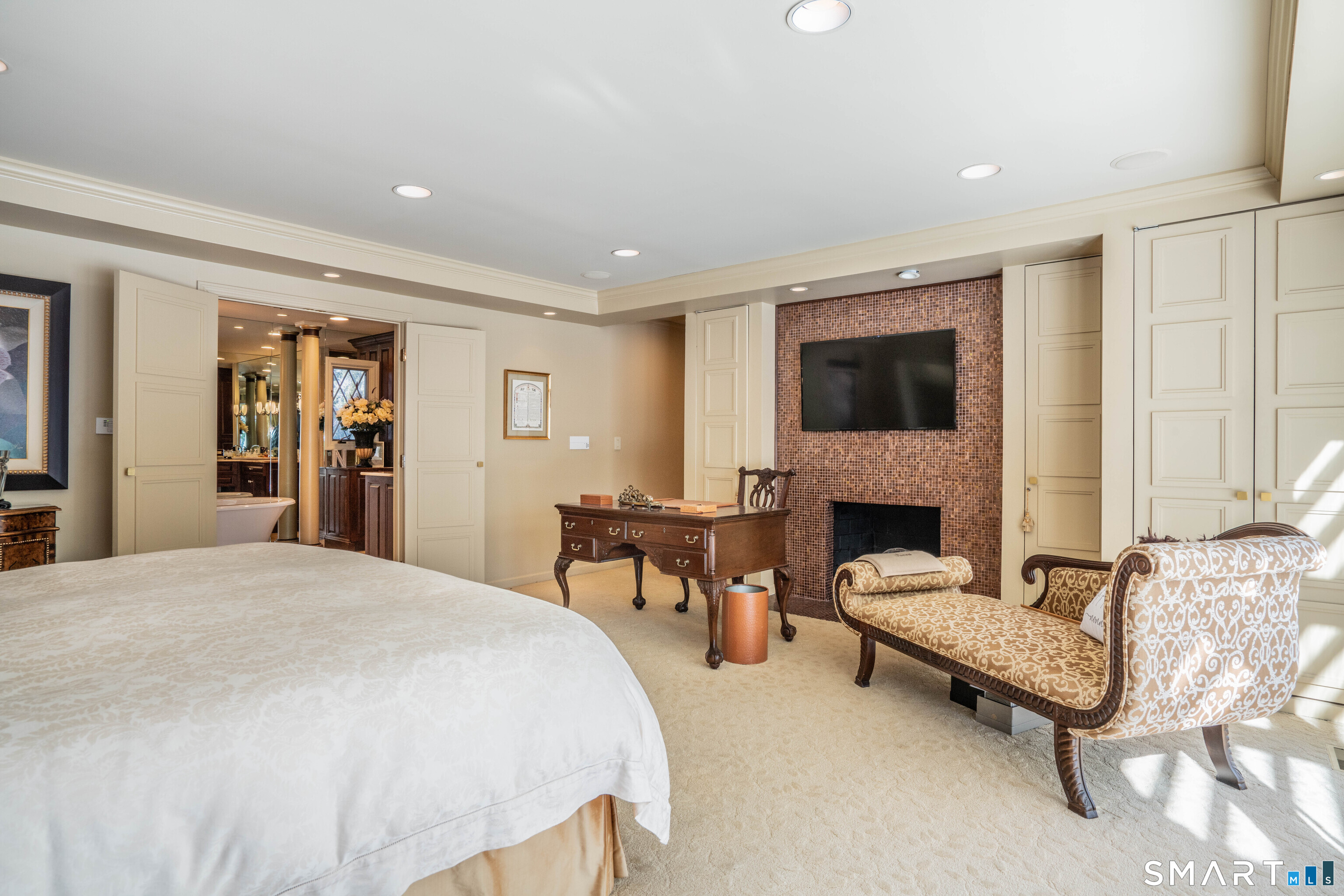 33 Mountain Farms Road West Hartford, CT 06117 - Photo 13 of 38 a spacious bedroom with a bed and a fireplace