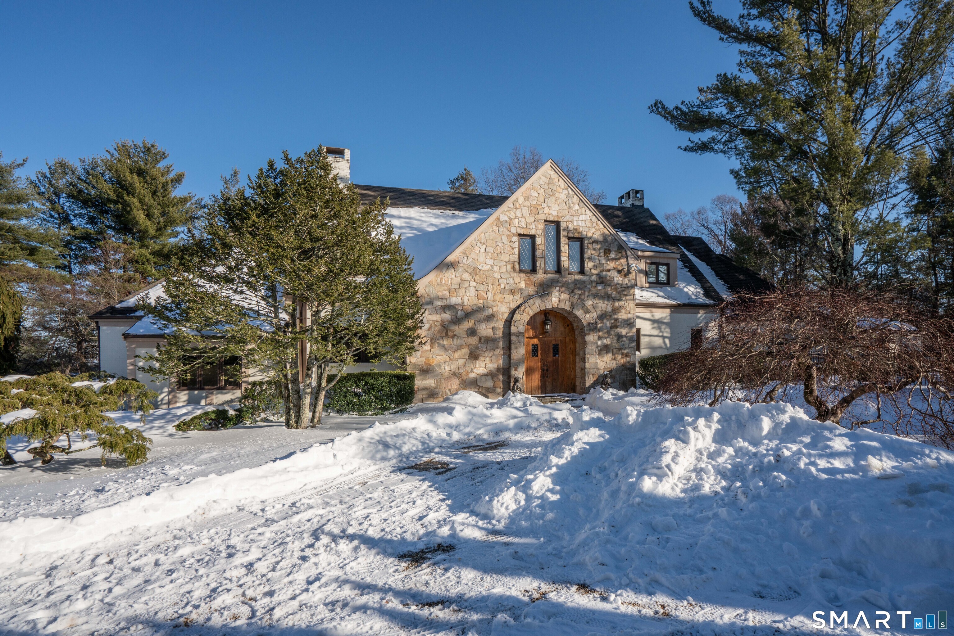 33 Mountain Farms Road West Hartford, CT 06117 - Photo 35 of 38 a front view of a house with a yard covered in snow