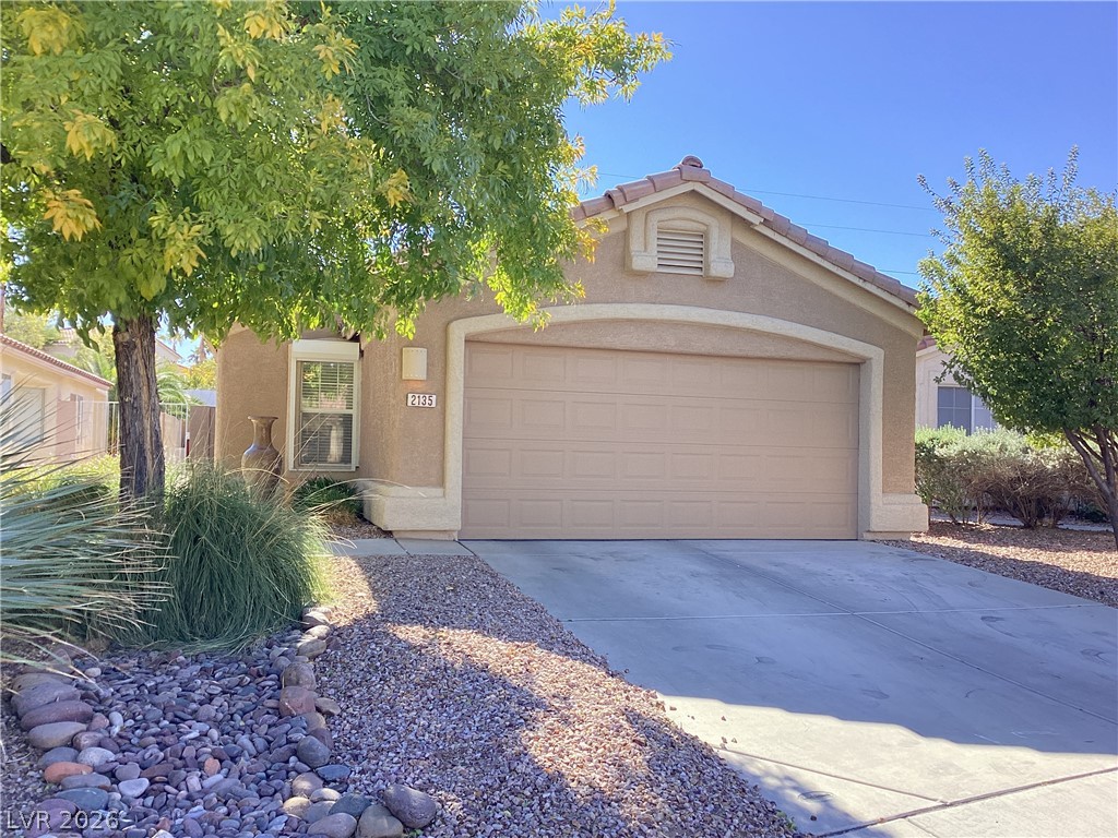 2135 Hidden Ranch Terrace Henderson, NV 89052 - Photo 1 of 27 A well-maintained stucco home with a two-car garage and mature desert landscaping offers curb appeal.