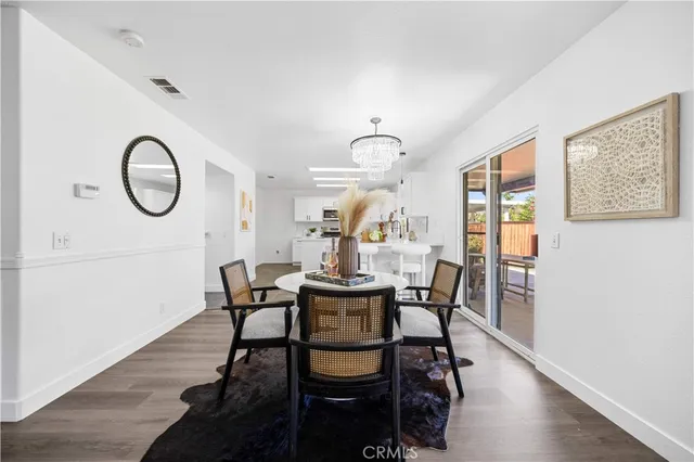 a dining room with furniture a window and wooden floor