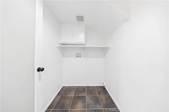 a view of a room with white cabinets