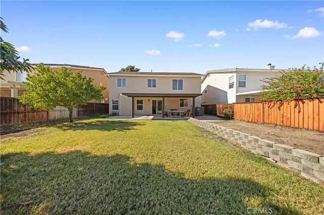 a front view of a house with a yard table and chairs