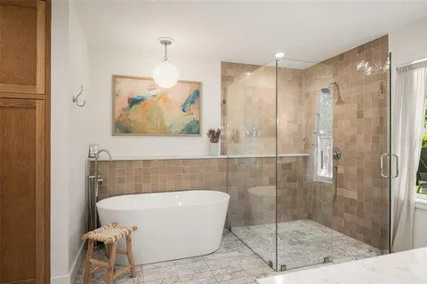 a bathroom with a bathtub and shower