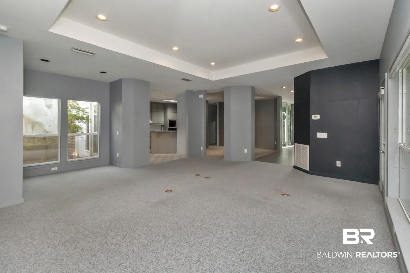 1205 Hillcrest Crossing East Mobile, AL 36695 - Photo 14 of 40 Unfurnished living room featuring a raised ceiling and light colored carpet