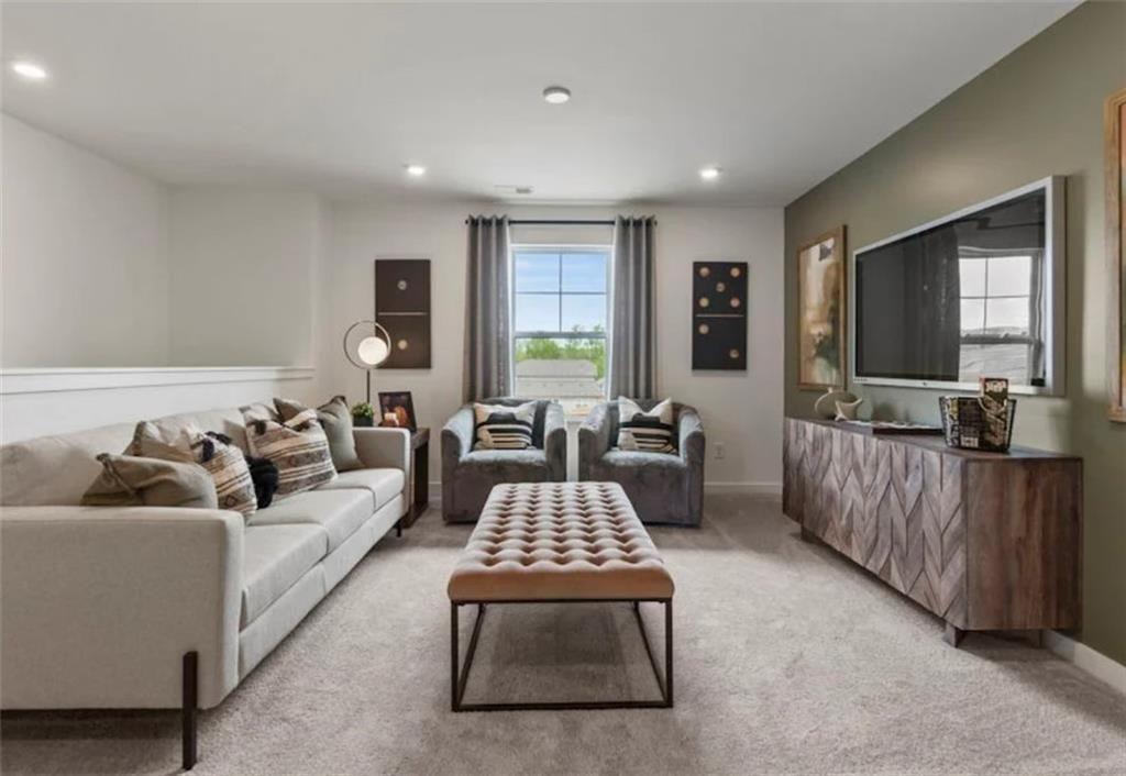 114 Poplar Blf Way Jefferson, GA 30549 - Photo 22 of 32 a living room with furniture and a flat screen tv