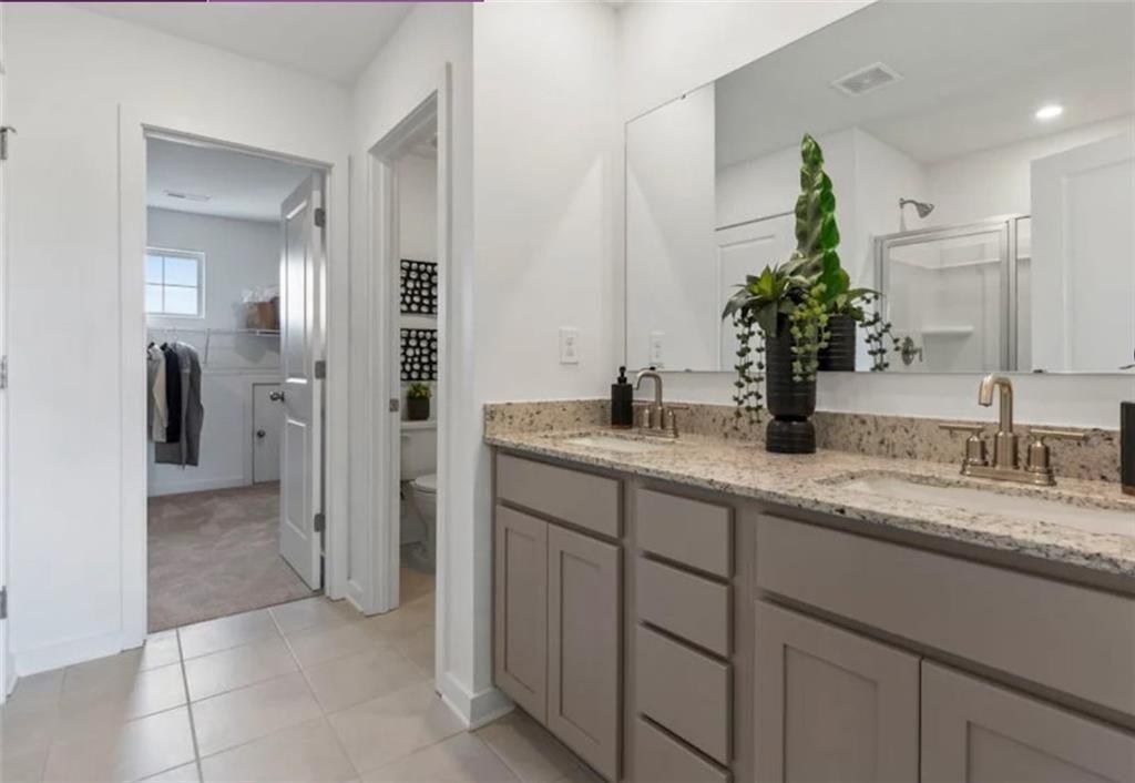 114 Poplar Blf Way Jefferson, GA 30549 - Photo 25 of 32 a bathroom with a granite countertop sink and a mirror