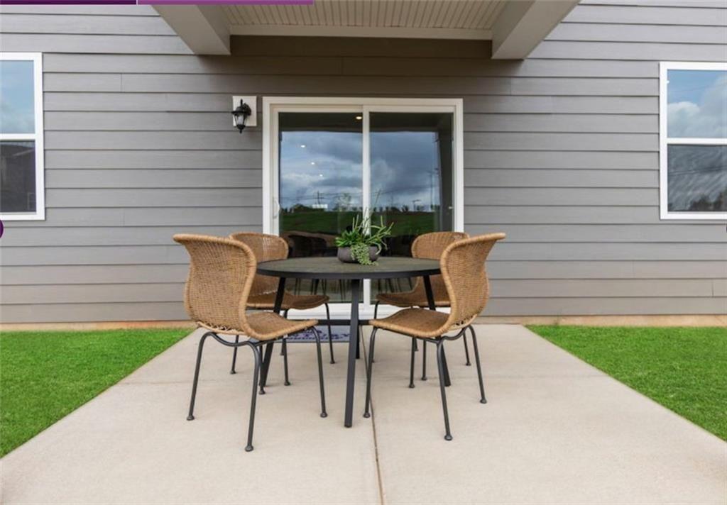 114 Poplar Blf Way Jefferson, GA 30549 - Photo 32 of 32 a patio with table and chairs and potted plants