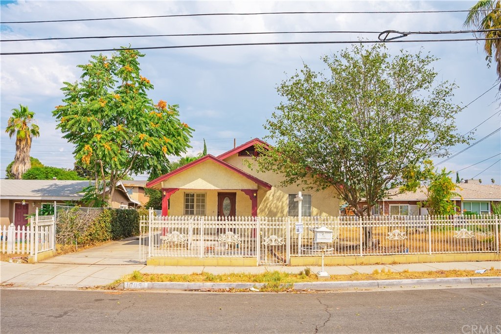 1795 Enterprise Avenue Riverside, CA 92507 - Photo 1 of 1 a front view of a house with a yard and a garage