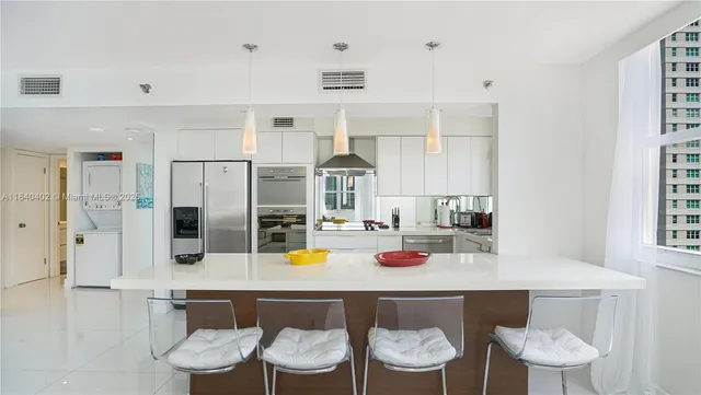 a kitchen with a table and chairs in it