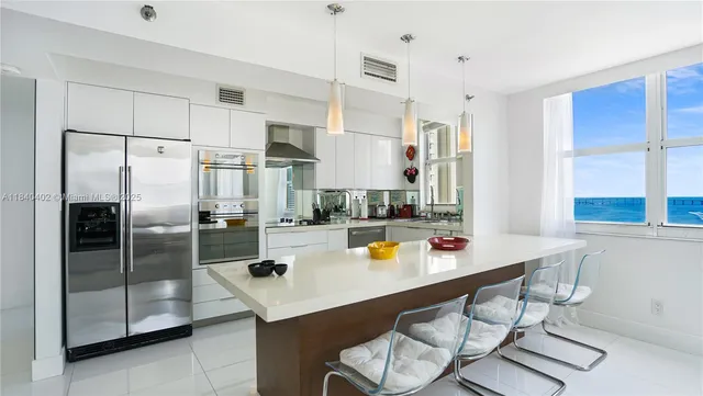 a kitchen with stainless steel appliances a refrigerator and a stove