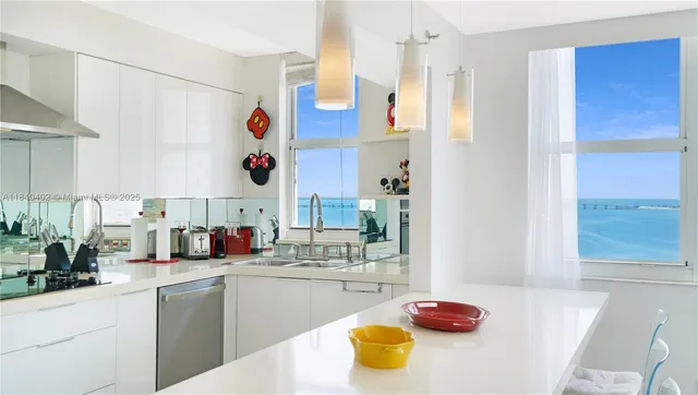 a kitchen with a sink appliances and cabinets