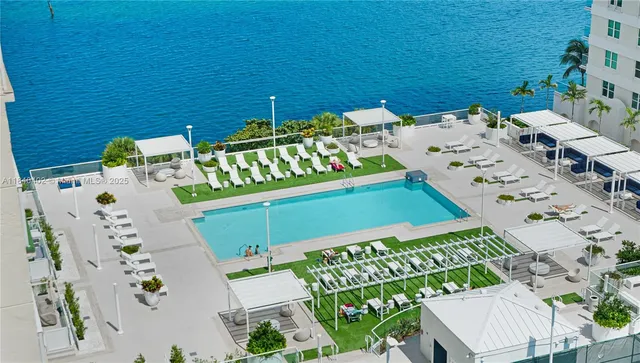 an aerial view of a pool patio deck and outdoor seating